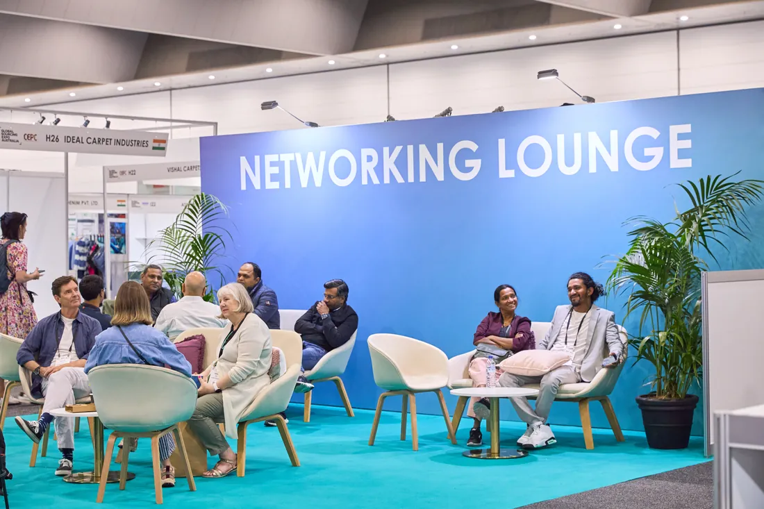Attendees talking in a networking lounge at a business expo